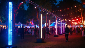 A photograph of a vibrant outdoor scene featuring led light stands in use during a nighttime event