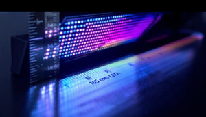 A photograph of a side-by-side comparison of a 165 mm led display and a ruler or measuring tape showing the equivalent length in feet