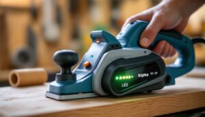 A photograph of a modern electric hand planer with a clear led display in action